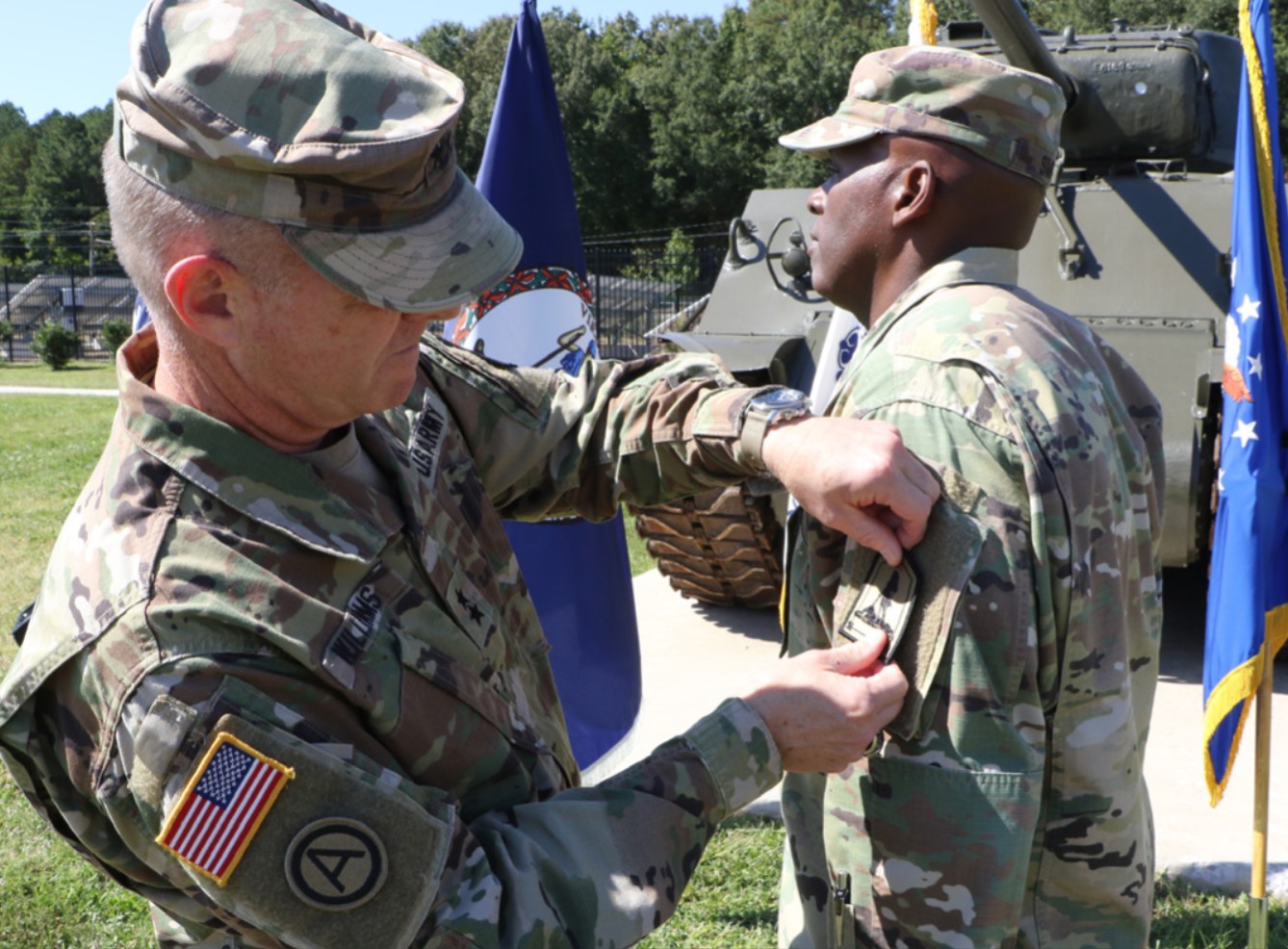 Maj. Gen. Timothy P. Williams places the Joint Force Headquarters - Virginia patch on the shoulder of Command Sgt. Maj. Ronald Smith during a ceremony Sept. 30, 2021, at Defense Supply Center Richmond, Virginia