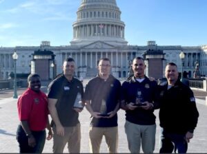 Leaders and recruiters from the Virginia Army National Guard pose together in front of the U.S. Capitol Nov. 16, 2023, in Washington, D.C. after three Virginia recruiters were named top in the region.