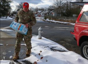 A Virginia National Guard Airman assigned o the 203rd Rapid Engineer Deployable Heavy Operational Repair Squadron supports water bottle distribution efforts Jan. 11, 2025, in Richmond, Virginia.