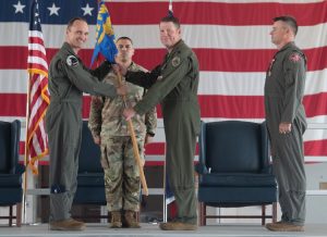 Col. Brock E. Lange passes the 192nd Operations Group guidon to Lt. Col. Matthew B. Woodfield, signifying his assumption of command of the group Aug. 10, 2025, at Joint Base Langley-Eustis in Hampton, Virginia.