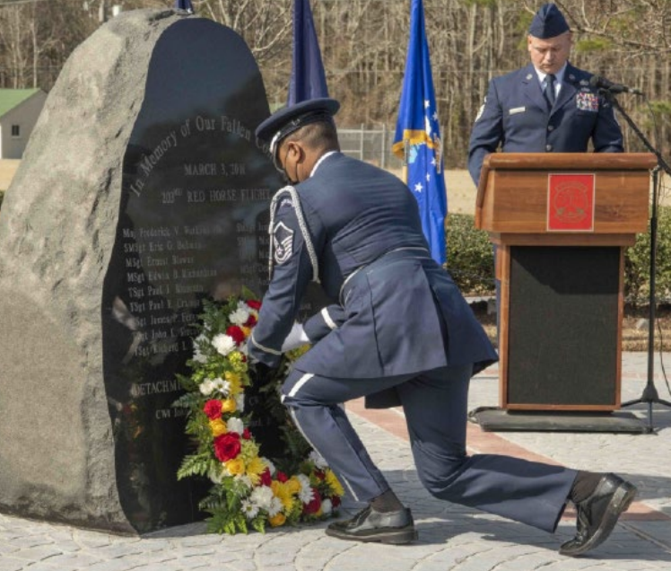 A member of the 203rd RED HORSE places a wreath at the memorial honoring the 21 lives lost in a plane crash in Unadilla, Georgia, on the 20th anniversary of the tragic incident. Eighteen VaANG Airmen and three Florida Army National Guard Soldiers perished in the crash.